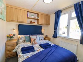 A bedroom with a bed and shelving at 25 Foxburrow Hang in Fritton near Belton