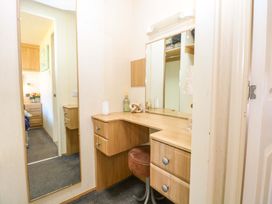 A dressing room with a vanity table and chair at 25 Foxburrow Hang Fritton near Belton