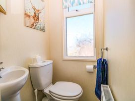 A bathroom with a toilet and sink at 25 Foxburrow Hang in Fritton near Belton
