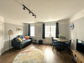 A living room with a sofa and dining table at Melanie's Cottage Brewers Quay Harbour