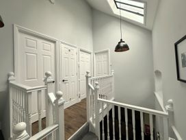 A hallway with stairs and doors at Melanie's Cottage Brewers Quay Harbour