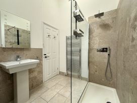 A bathroom with a sink and shower at Melanie's Cottage Brewers Quay Harbour
