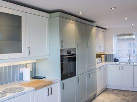 A kitchen with cabinets and appliances at Firm Anchor in Salcombe