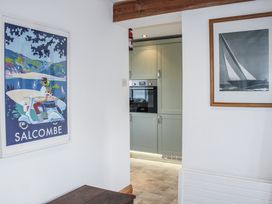 A kitchen with a poster and oven at Firm Anchor in Salcombe