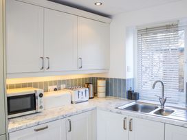 A kitchen with appliances and a sink at Firm Anchor in Salcombe