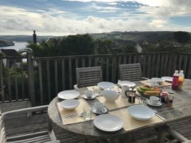 A dining table set with plates and drinks at Firm Anchor in Salcombe