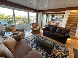 A living room with sofas and a dining area at Firm Anchor in Salcombe