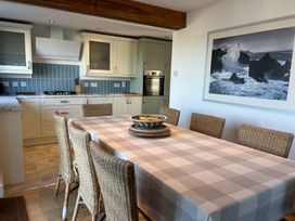 A dining room with a table and chairs at Firm Anchor in Salcombe