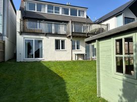 A garden with a house and deck at Firm Anchor in Salcombe