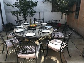 A dining area with a table set for a meal at Firm Anchor in Salcombe
