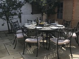 A dining table set with wine and fruit at Firm Anchor in Salcombe