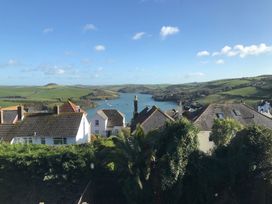 A view of houses and water with hills in the background at Firm Anchor in Salcombe