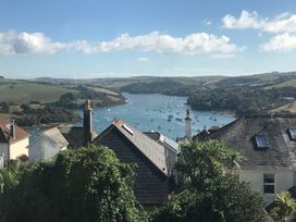 A view of boats on water surrounded by hills and houses at Firm Anchor in Salcombe