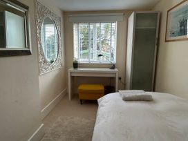 A bedroom with a bed and desk at Firm Anchor in Salcombe