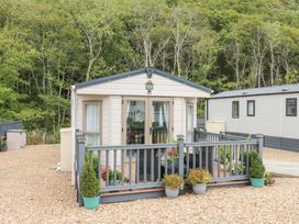 A holiday home with decking and flower pots at The Haven in 