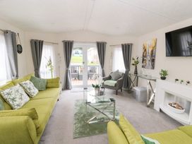 A living room with green sofas and decorative items at The Haven