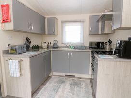 A kitchen with cabinets, sink, and appliances at The Haven