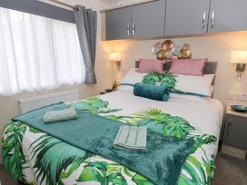 A bedroom with a bed and decorative items at The Haven 