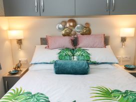 A bed with pillows and decorative plates above in a bedroom at The Haven