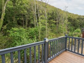 A deck overlooking trees and greenery at The Haven 