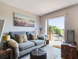 A living room with a sofa and television at Piglet Corner in Culmstock