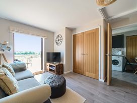 A living room with a sofa and television at Piglet Corner in Culmstock