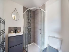 A bathroom with a shower, toilet, and sink at Piglet Corner in Culmstock
