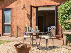 An outdoor space with chairs and a table at Piglet Corner in Culmstock