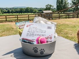 A basket with pet goodies and a welcome note at Piglet Corner in Culmstock