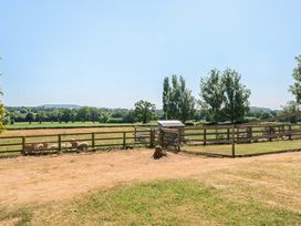 An outdoor area with a fence and sheep at Piglet Corner in Culmstock