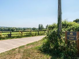 A road leading to Oakdale Farm with fields in the background at Piglet Corner Culmstock