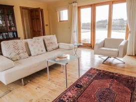 A living room with a sofa and coffee table at Cashelrehine Falcarrheh