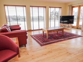 A living room with a coffee table and television at Cashelrehine in Falcarrheh