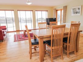 A dining room with a table and chairs at Cashelrehine in Falcarrheh
