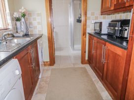 A kitchen with appliances and a shower stall at Cashelrehine in Falcarrheh