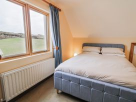 A bedroom with a bed and window at Cashelrehine Falcarrheh