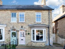 The front of a brick house with a bay window and two arched doorways at Thorncliffe House in Pocklington