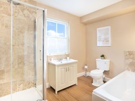 A bathroom with a shower enclosure a vanity unit a toilet and a bathtub at Thorncliffe House in Pocklington
