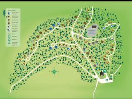 A map showing cabins and facilities in a forest with roads and trees at Glentress The Unfurl Cabin in Glentress Forest Peebles