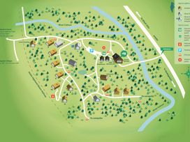 A map of a cabin site showing cabins numbered 1 to 17 with roads rivers trees parking and nearby railway at Beddgelert Golden Oak - freshly inspired design Beddgelert Eryri Snowdonia