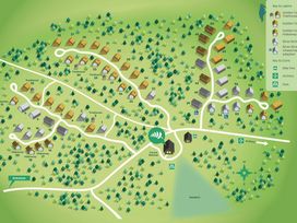 Map showing cabins labeled by numbers and types including treehouses and hideaways with paths and icons for bike hire archery and park at Blackwood Forest Golden Oak in Blackwood Forest