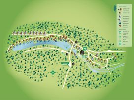 A map of a forest resort showing cabins lakes paths and amenities at Deerpark Classic Golden Oak in Deerpark Forest