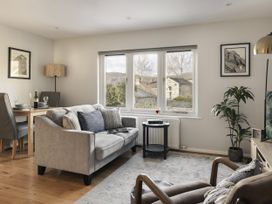 A living room with a sofa and dining table at Rydal Apartment Ambleside in Ambleside