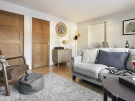 A living room with a sofa, armchair, coffee table and a record player at Rydal Apartment Ambleside in Ambleside