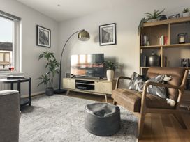 A living room with a television and a chair at Rydal Apartment Ambleside Ambleside