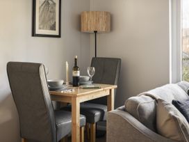 A dining area with a table and chairs at Rydal Apartment Ambleside