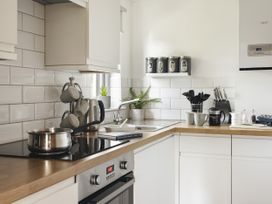 A kitchen with pots and utensils on the counter at Rydal Apartment Ambleside