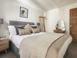 A bedroom with a bed and bedside table at Rydal Apartment Ambleside