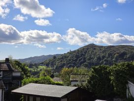 A view of a mountain and trees at Rydal Apartment Ambleside in Ambleside
