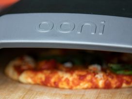 Close up of a pizza inside an Ooni pizza oven